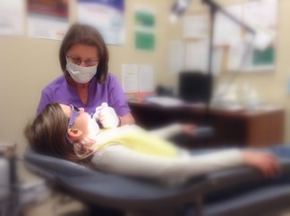 girl getting teeth checked over